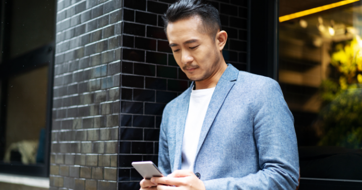 A man is scrolling through his phone.